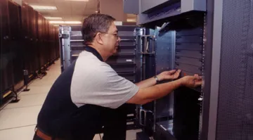 Technician working on server racks in a data center